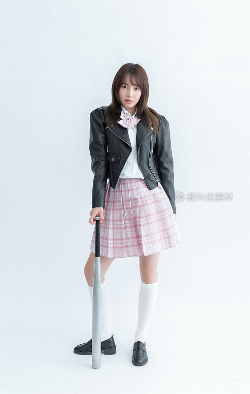 Asian school girl in a black leather jacket holding a baseball bat